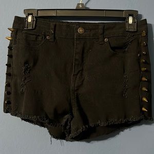 Black denim shorts with metal spikes